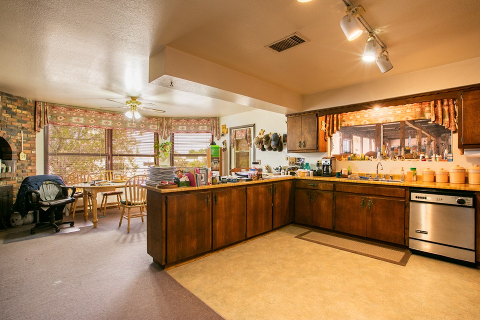 large country kitchen with big bay/bow window. built in jenn aire appliances and a fireplace.