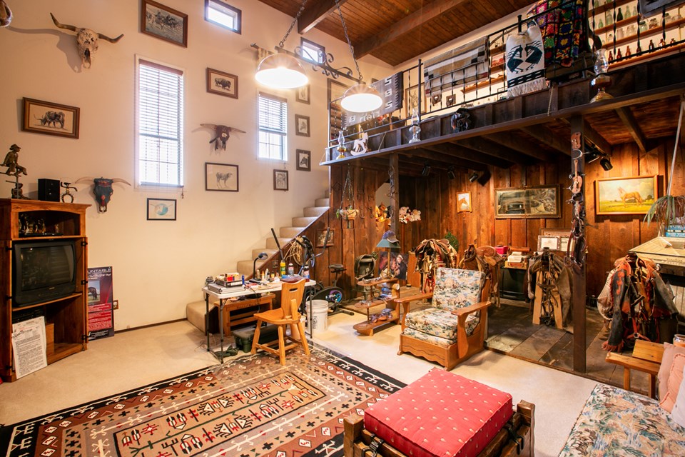 huge den or hobby room. could also be a 4th bedroom. stairs lead up to a loft that goes to a 2nd master bedroom. there is a fireplace in this room also.